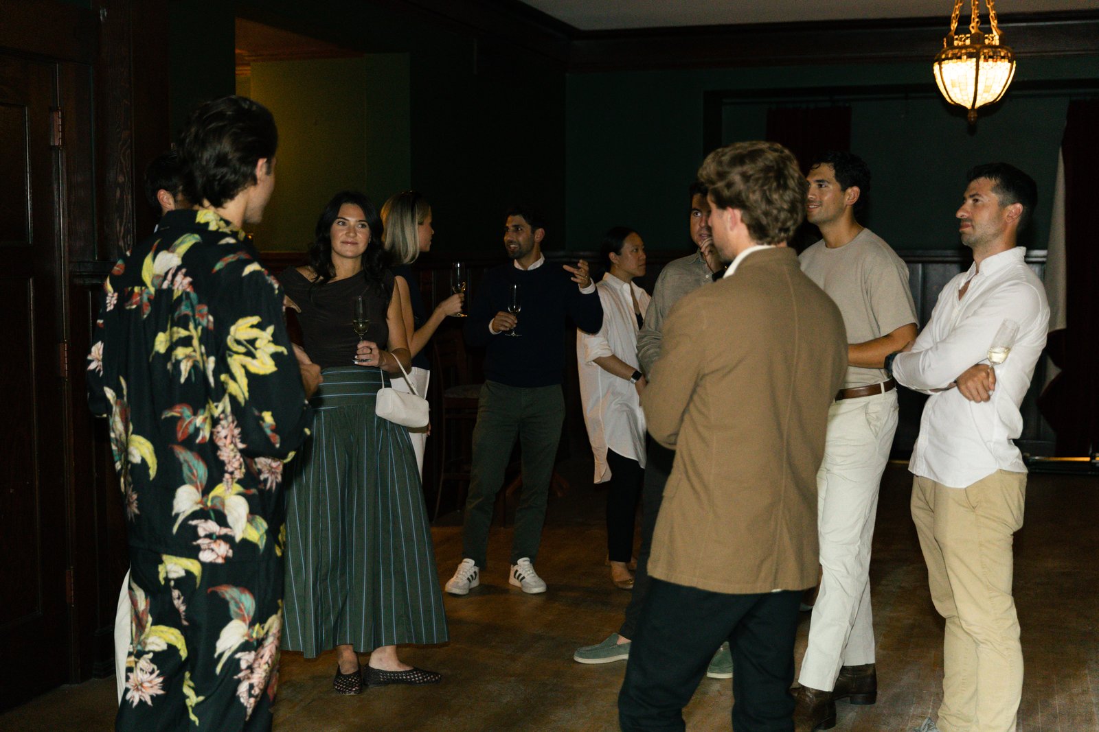 Guests gathered with drinks in a room at The Baillie